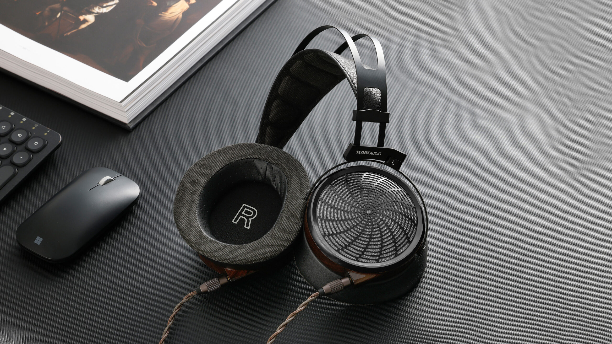 Handcrafted zebrawood earcups and a distinctive metal grille give the Apollo PRO a premium look that matches its audiophile ambitions.